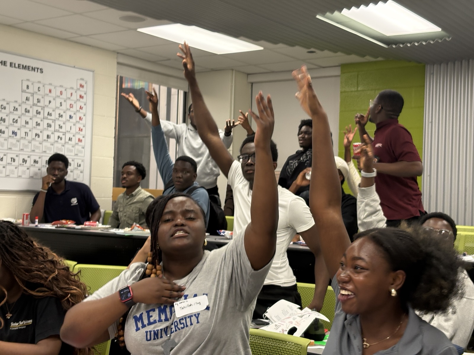 Members raising their hands and cheering during a game